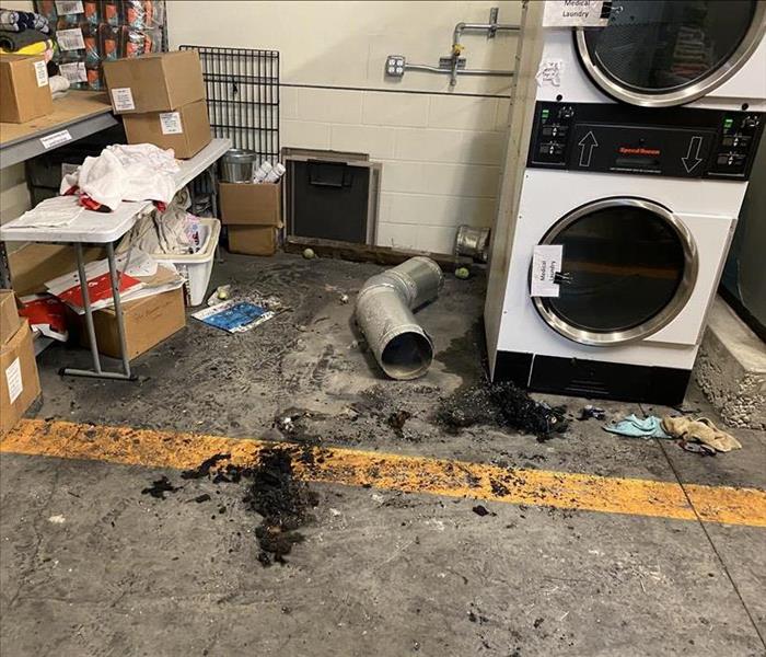 Soot and damage from fire in laundry room 