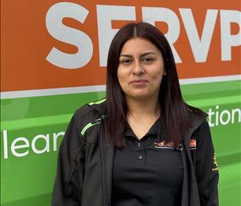 female employee against a green background