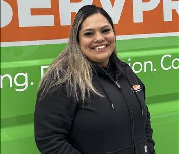 female employee against a green background